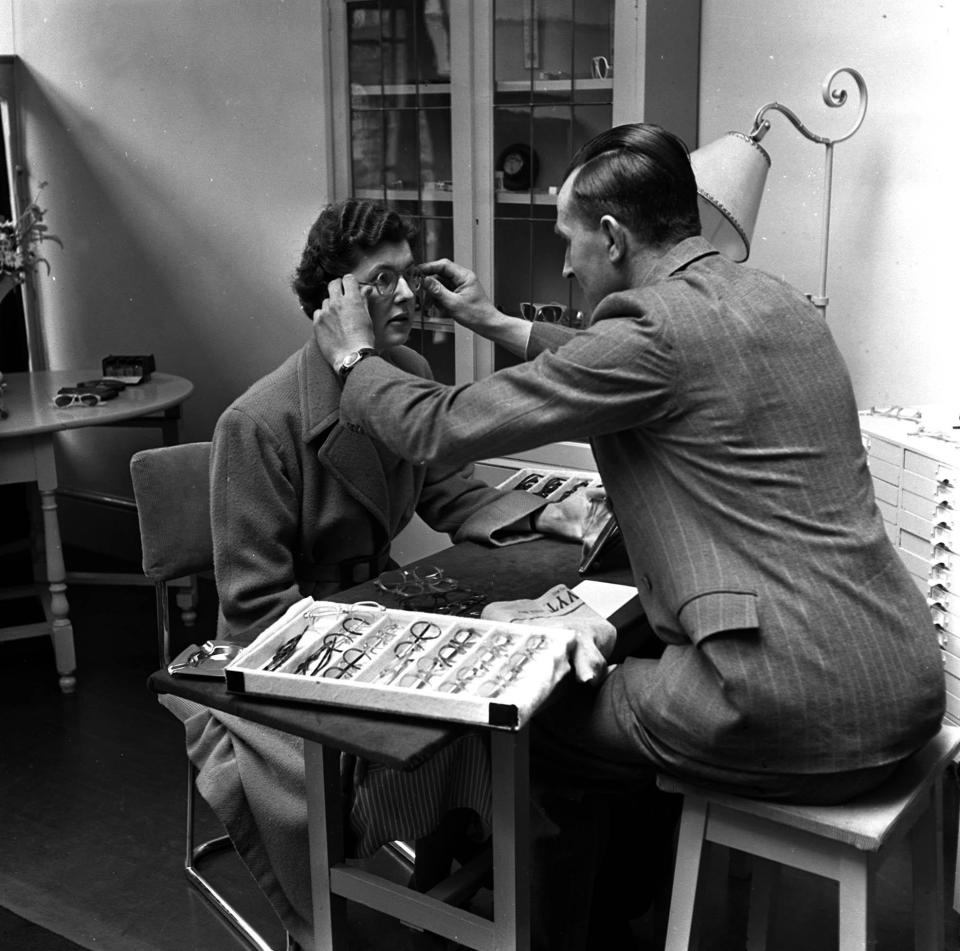 1951: The National Health Service at work in Portsmouth, here a lady tries out her new glasses as eighteen million pairs have been supplied on the NHS