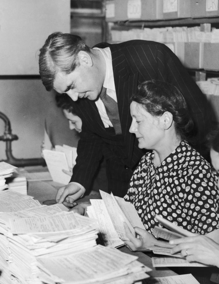 Health Minister Aneurin Bevan inspects health cards during a visit to Insurance House in Holborn, to check the progress of the new NHS. As many as 40,000 new applications were dealt with every day by the clerks