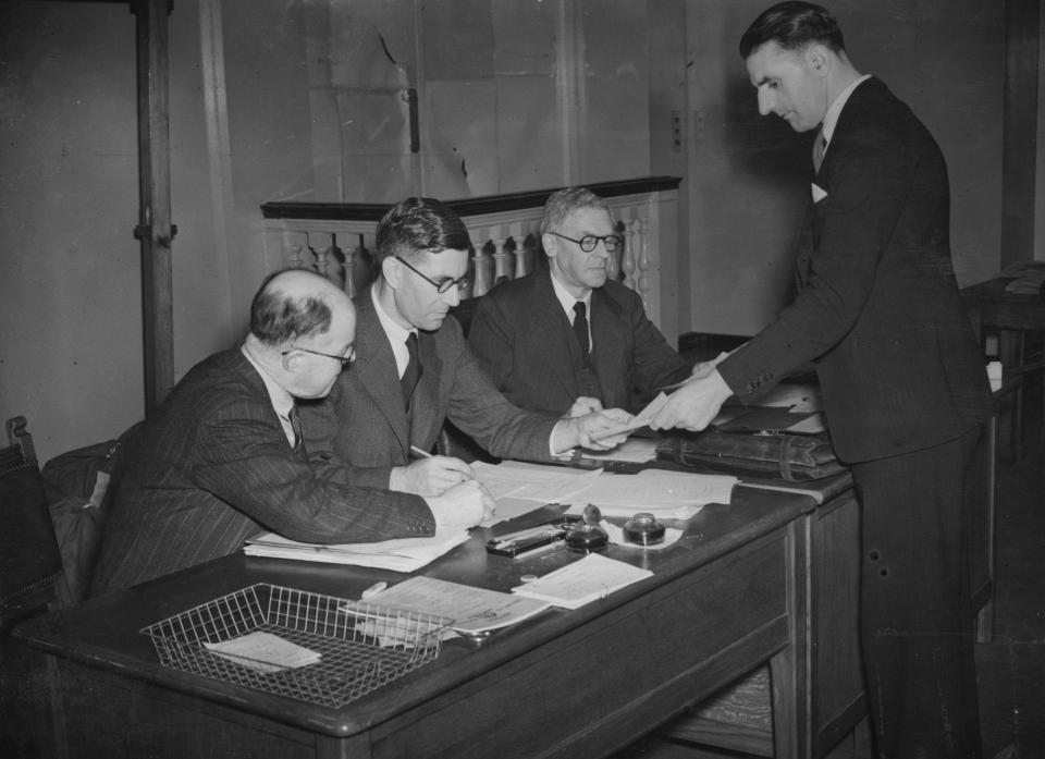 A Twelftree, chief clerk BMA; Dr J Revans, assistant secretary; a representative from Price Waterhouse; and G Perkins at BMA House, London, during the sorting of ballot papers in the British Medical Association's 2nd plebiscite to ascertain doctors' views on joining the National Health Service scheme