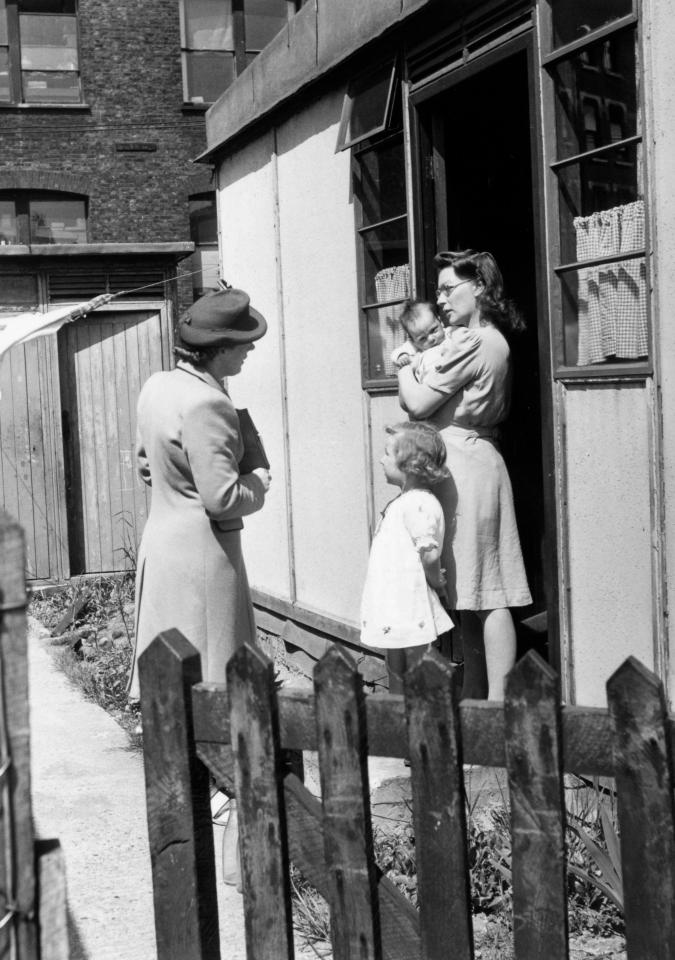  A health worker visits the house of a mother and her children as part of the NHS