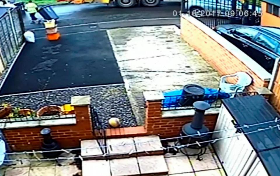  Homeowner can be seen in the right-hand corner of the frame driving away as binman takes his bin