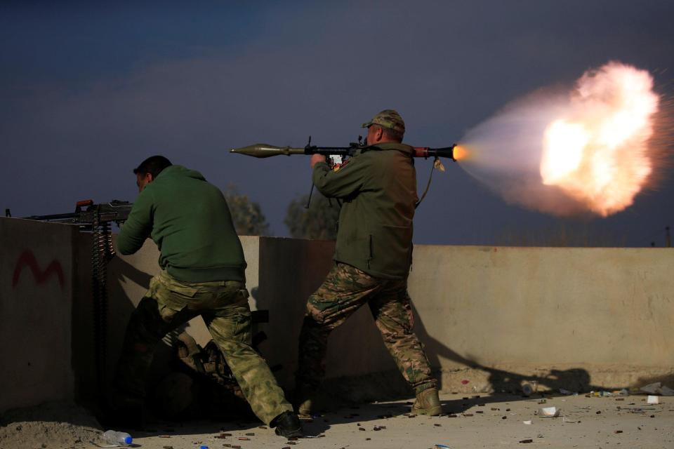  A member of Iraqi rapid response forces fires a rocket launcher during a battle with Islamic State militants