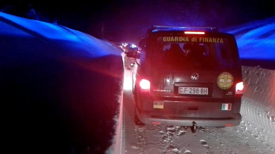  A convoy of emergency vehicles makes its way through the snow to Hotel Rigopiano last night