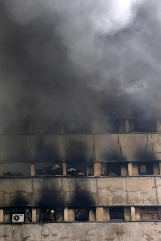  Thick black smoke filled the sky before the structure rumbled to the floor