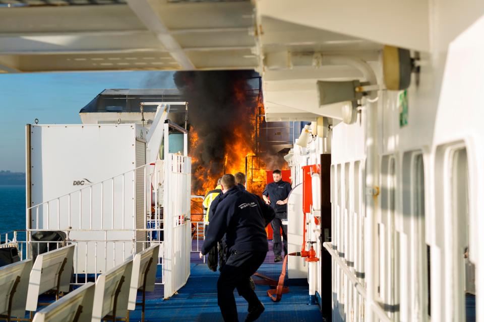  Staff on board the Wightlink ferry rush to douse the flames after a fire broke out on board the vessel this morning