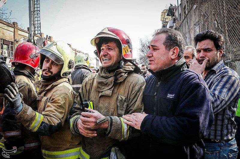  A look of anguish plays across the face of firefighter as he surveys the scene