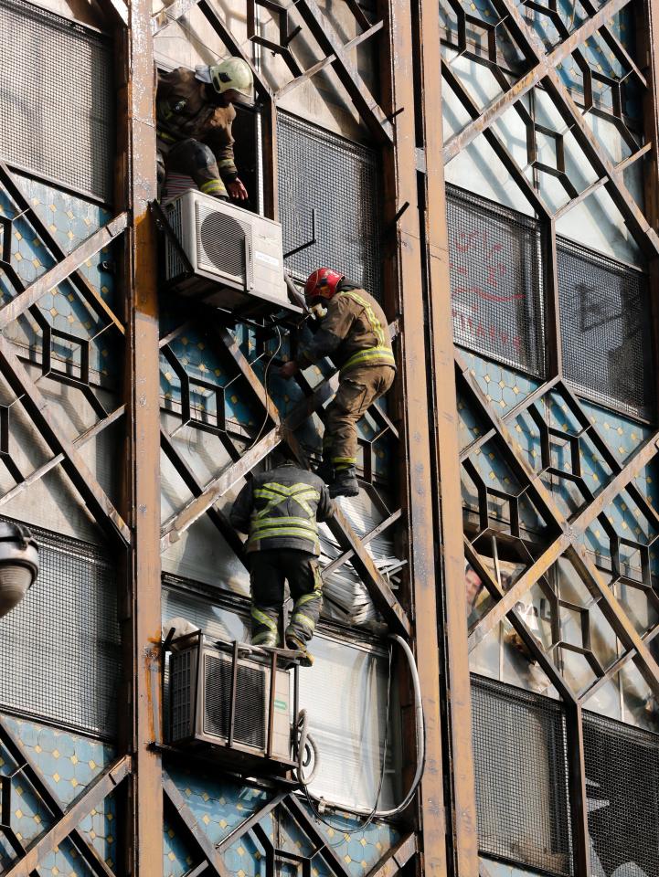  Fire fighters scrambled down the side of the burning building in an effort to escape the flames