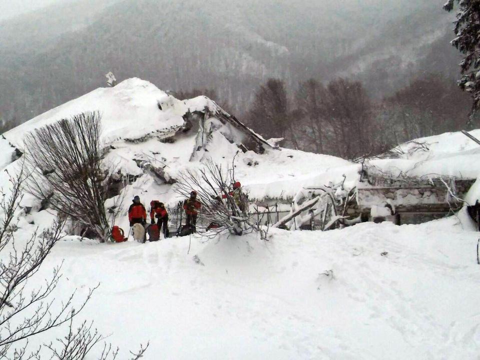  Rescuers work in front of the Rigopiano Hotel today