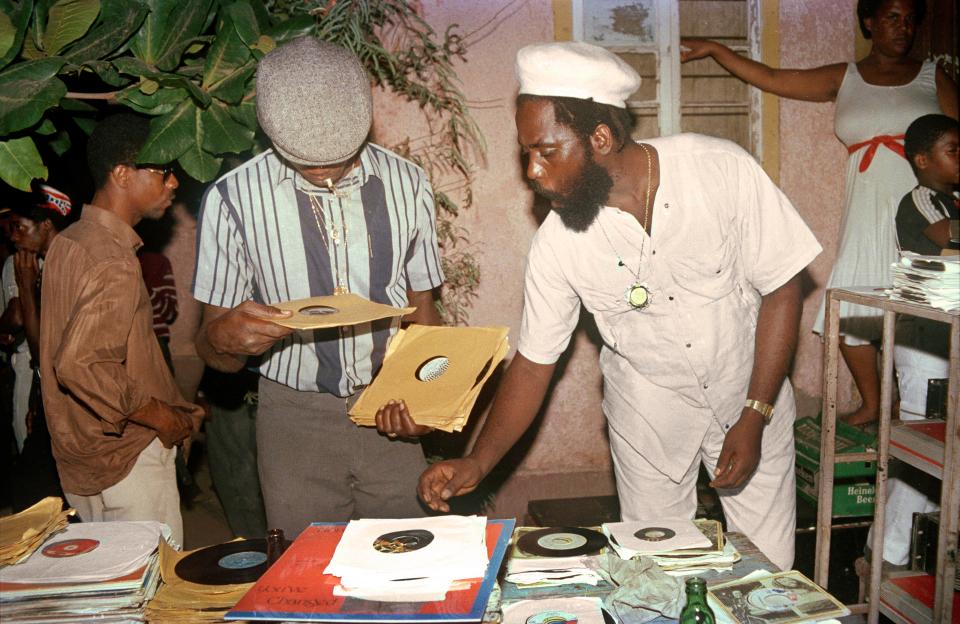  Jah Stitch picking out duplates at a Youth Promotion dance at Sugar Minott’s yard