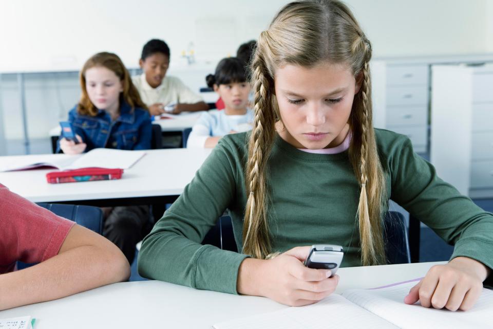  Debate is raging over whether mobile phones should be banned from schools