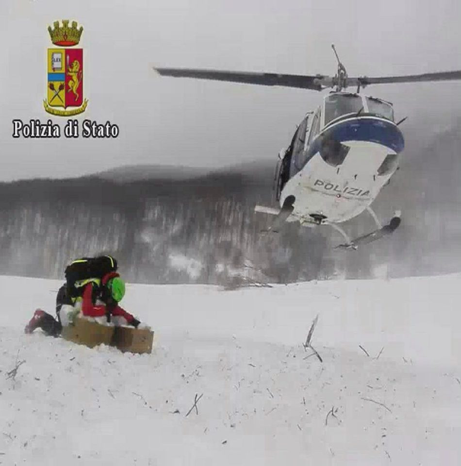  An Italian Police helicopter takes off after landing to supply food for rescuers at the hotel