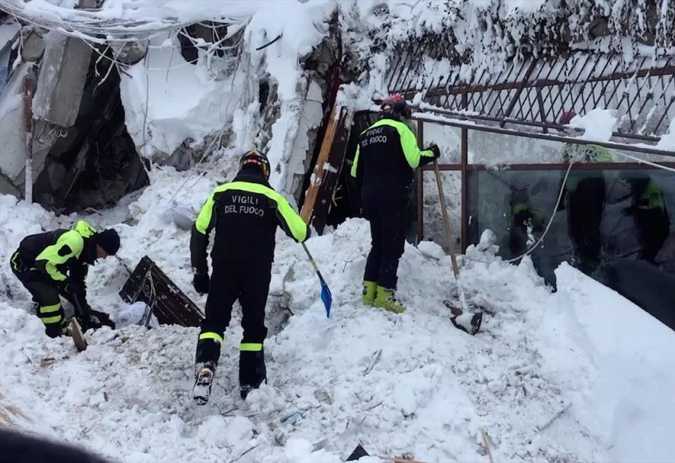  Emergency workers dig in the snow in an effort to reach survivors