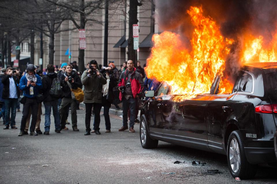  Elsewhere violence broke out across Washington, with protesters setting cars on fire