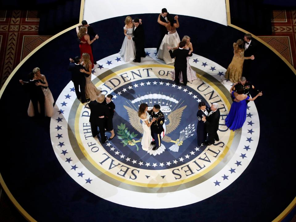  The Trump family dance with US military service members in front of crowds of people