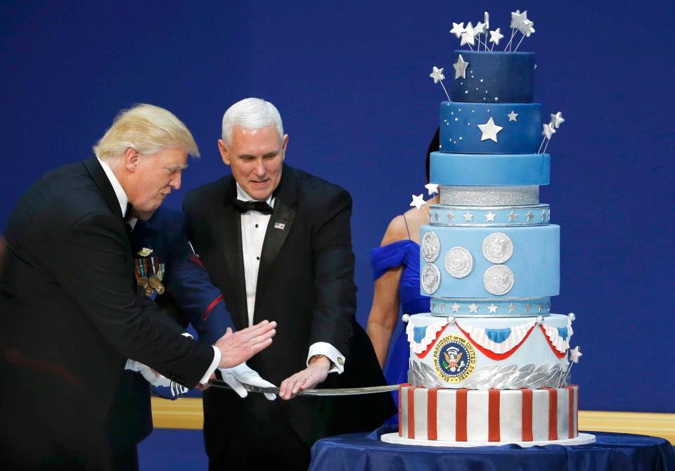  President Donald Trump and Vice President Mike Pence prepare to cut a cake with a sword at the Salute to Our Armed Forces inaugural ball