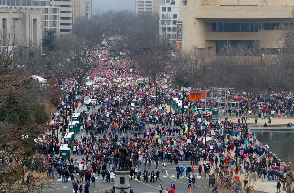  As Trump attended church, tens of thousands marched on Washington to protest against the new President