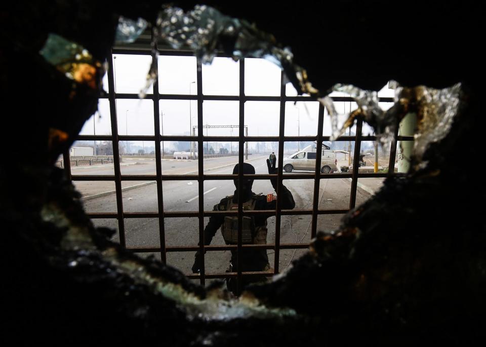  A member of the Iraqi special forces gestures as he stands near a bomb-rigged vehicle that was disarmed in the Andalus neighbourhood in the city of Mosul