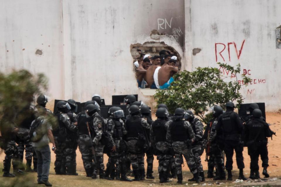  Inmates, top, watch as police officers enter the Alcacuz prison amid tension between rival gangs