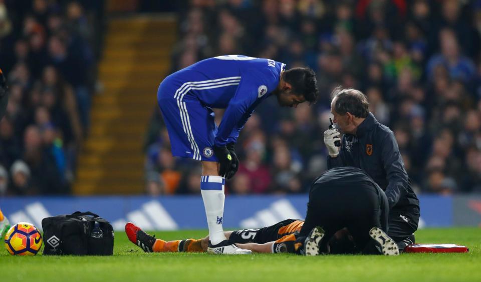 Diego Costa checks on the health of Ryan Mason as the Hull midfielder lies flat out on the pitch