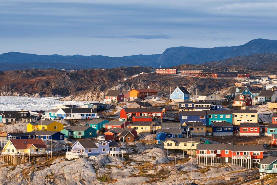  Brightly painted houses are dotted around the barren landscape of Ilulissat, Greenland