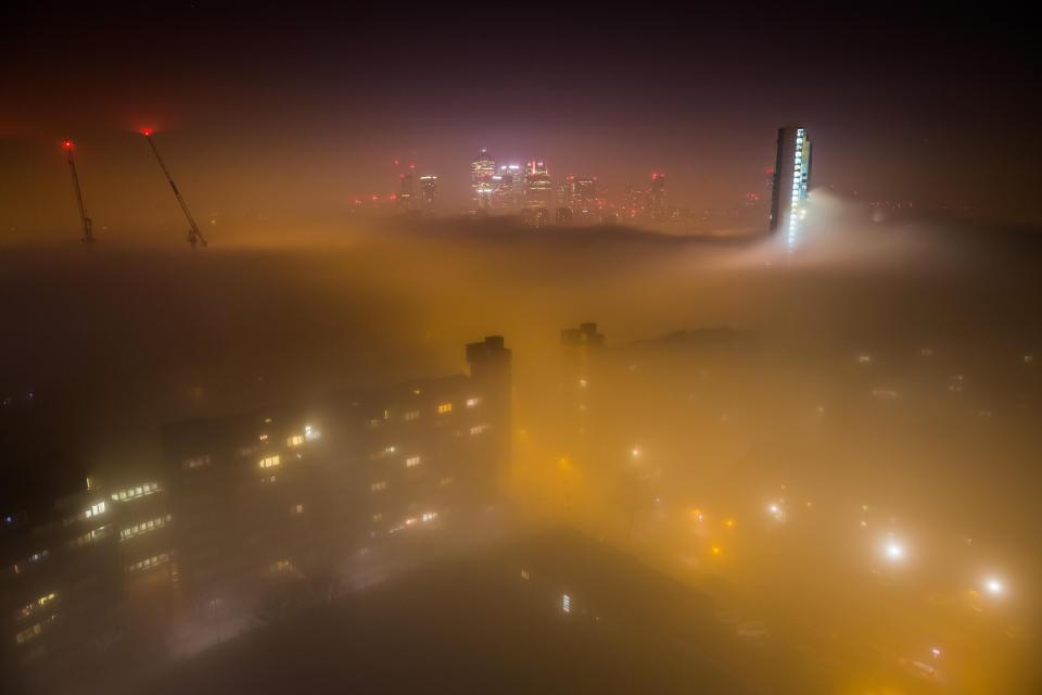  The capital's skyscrapers appear to disappear under the blanket of fog