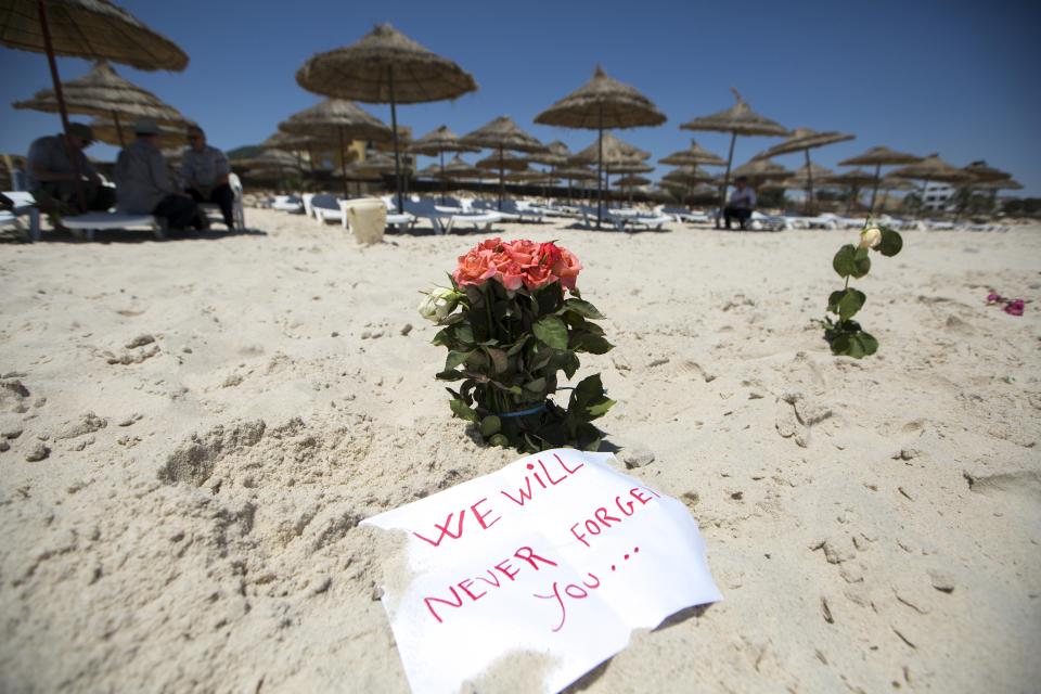  Tributes left at the site of the massacre with an inquest now being held into the final moments of the victims