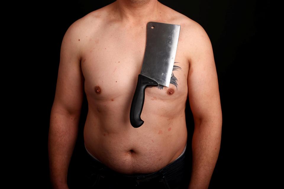  Nermin Halilagic, 38, poses with a meat cleaver which he claims sticks to his body because of a 'special energy'