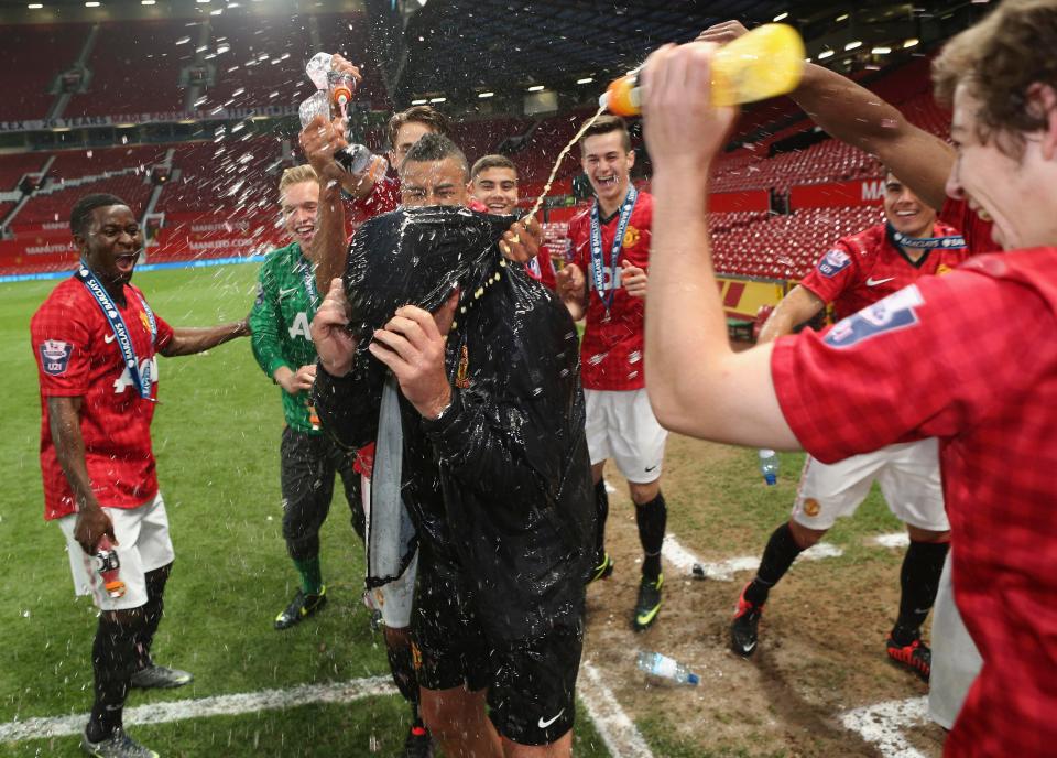  Wigan manager Warren Joyce is drenched after United U21's win the Elite Group Final