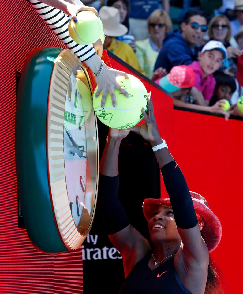  Serena Williams wears a cowboy hat as she signs autographs after her victory