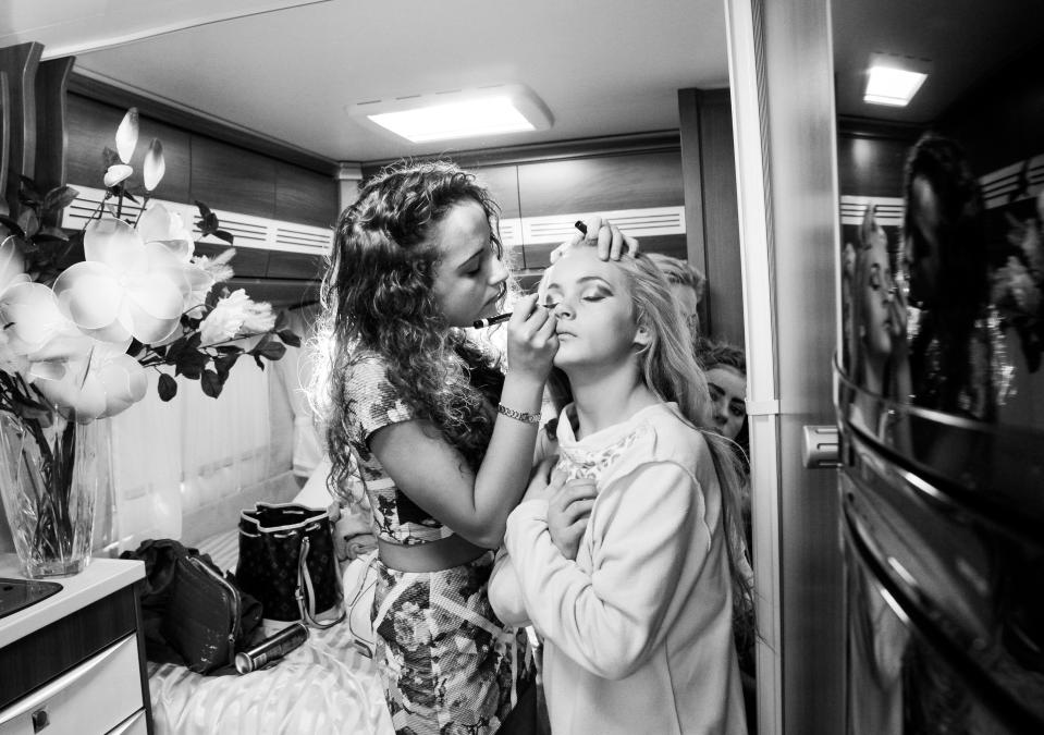  Girls help each other with make-up at the fair, where they may be married off