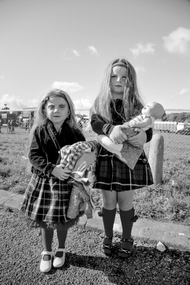  Two little girls play with a dolly