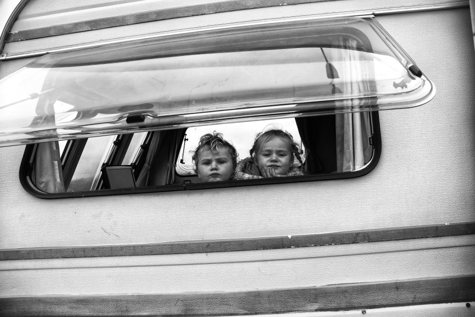  Two little ones look out of their caravan window