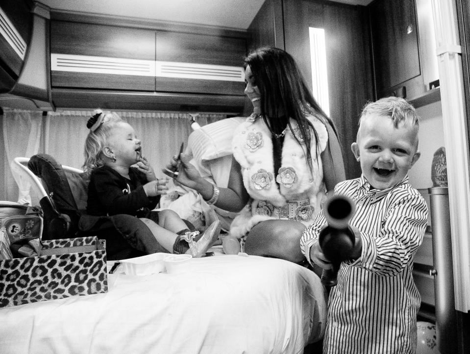  A tot plays a toy gun while his little sister plays with make-up