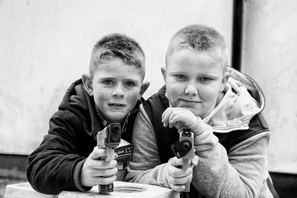  The two boys are pictured playing with plastic guns at the fair