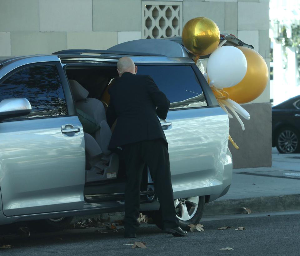  Gold and white balloons were also packed into the back of the car