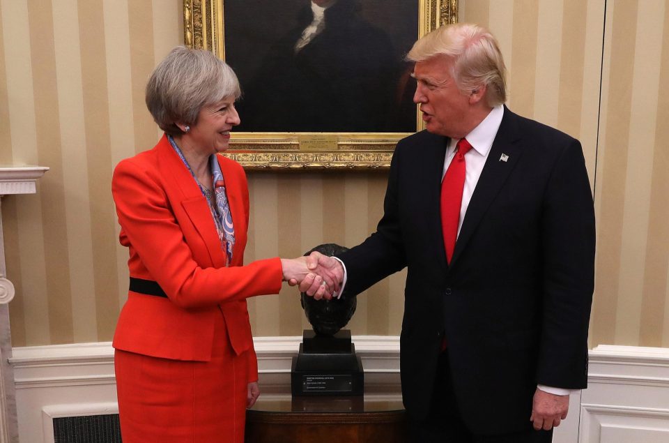  Did May subtly assert her authority when she placed her hand over the top of Trump's?