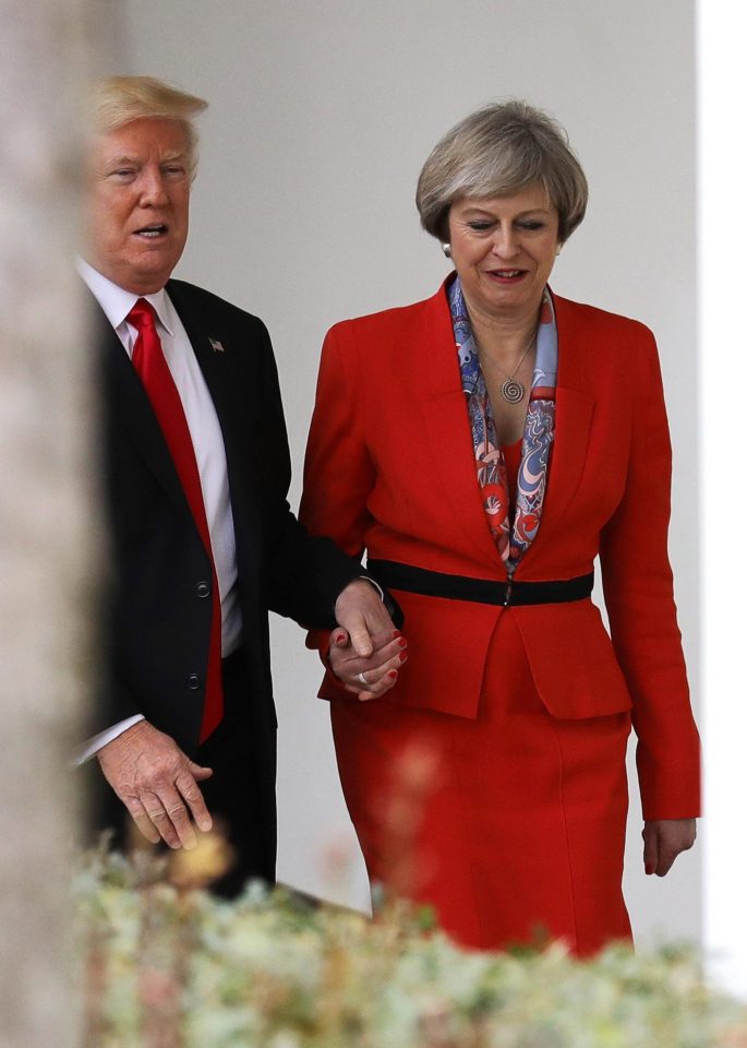  The US President was snapped holding hands with Theresa May yesterday