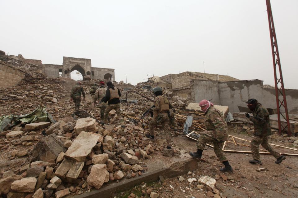  Soldiers inspect the site which was ravaged by jihadists who reportedly dug up the grave of Prophet Yunus