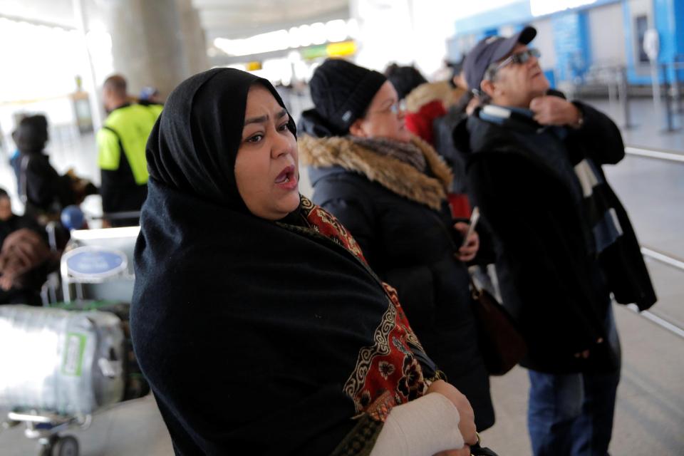 A Muslim woman waits for her family to arrive at the airport in New York