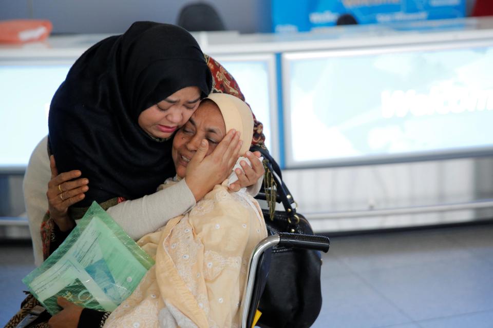 A woman greets her mother after she arrived from Dubai at John F. Kennedy International Airport in New York