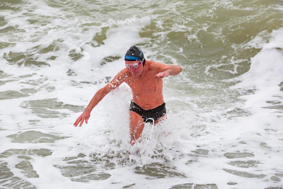 Despite it still being quite cold, a man and woman took on the powerful waves