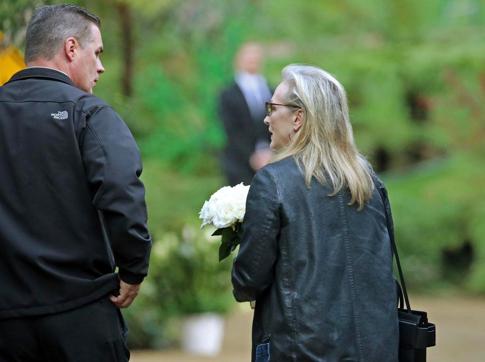  Streep was pictured carrying a bunch of white roses as she entered the compound, which has security guards posted at two points