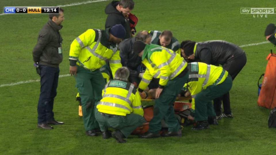 Medics and doctors from both clubs tend to the stricken Mason