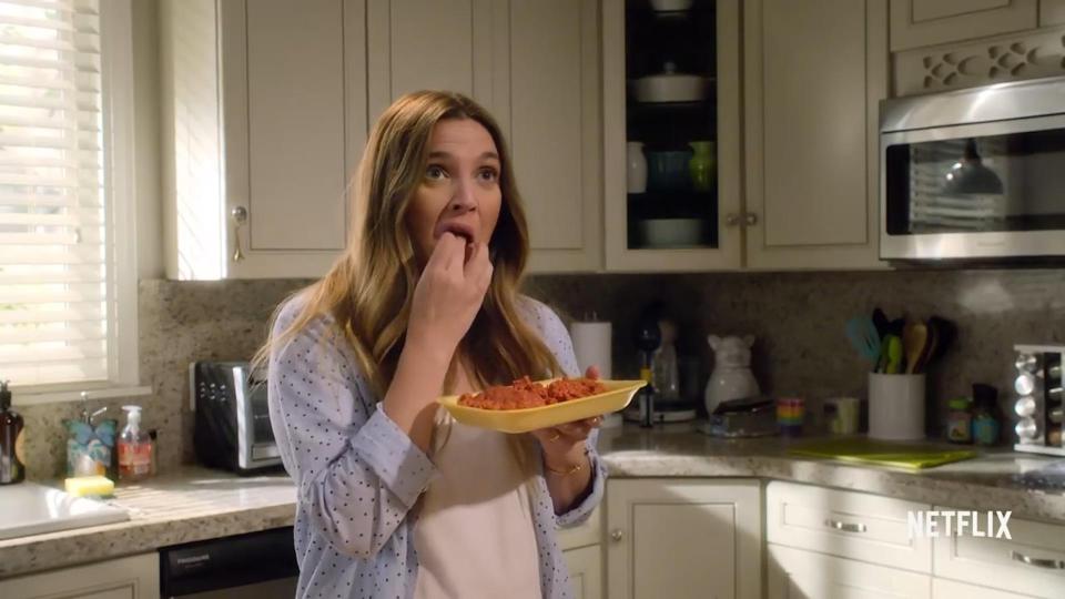  Flesh eating zombie estate agent Sheila, played by Drew Barrymore, enjoys some comfort food in an episode of Santa Clarita Diet