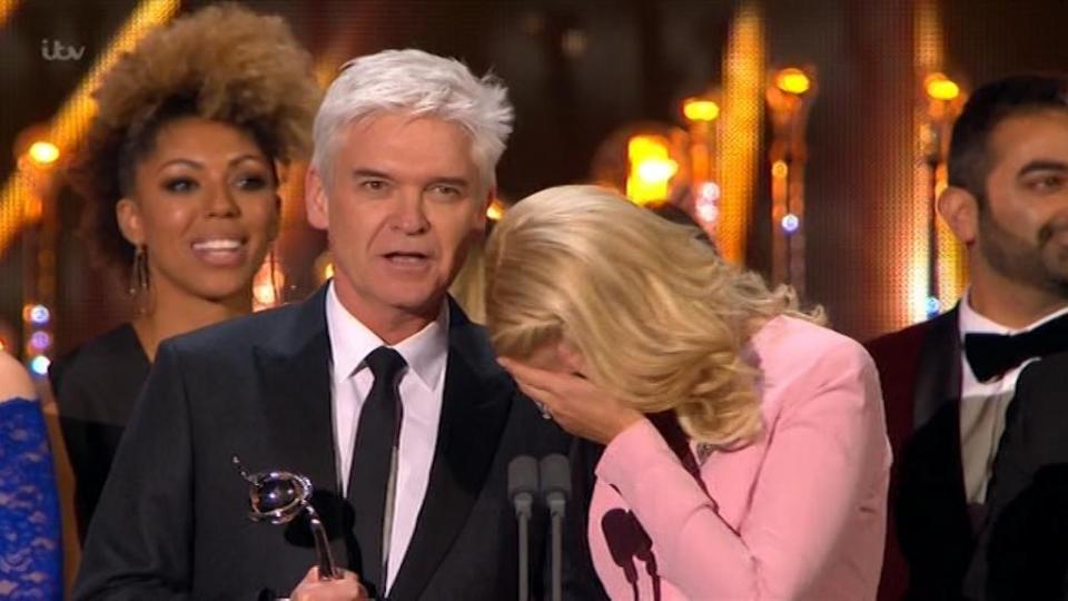  Holly laughed into Phil's shoulder as he spoke on behalf of the pair of them