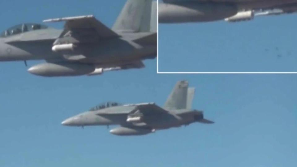  The drones can barely be seen as they are released from three fighter jets