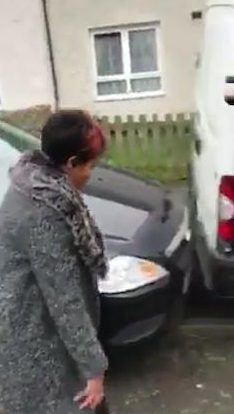  The car is parked just millimetres behind the van but the woman refuses to move it