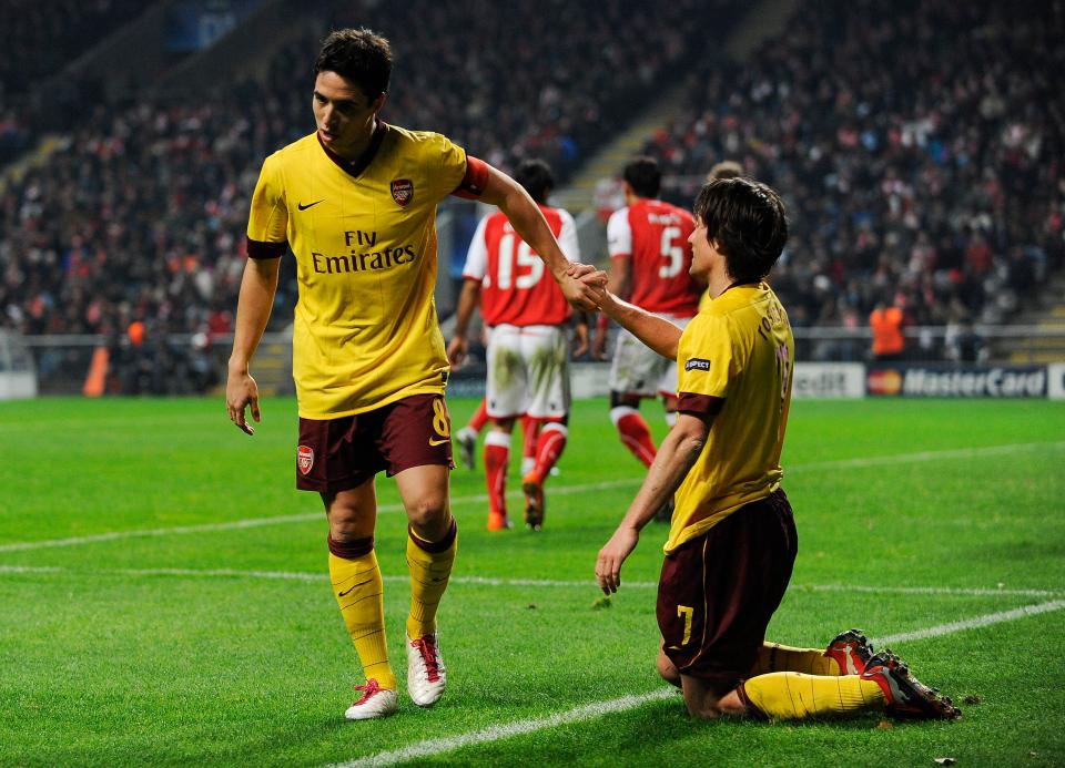 Samir Nasri helps up Tomas Rosicky during Arsenal's loss to Braga