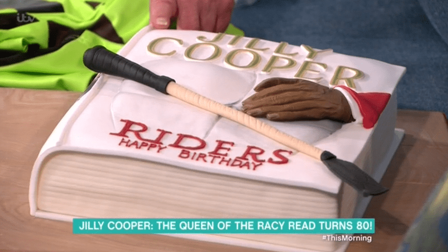  Jilly was presented with a cake shaped like her book Riders