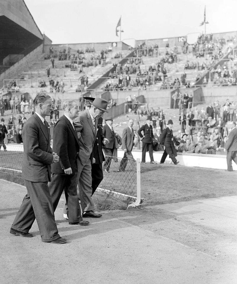  Sir Matt Busby is helped off the pitch shortly after returning from Munich hospital